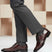 Lifestyle shot of bugatti Rico Flex bordo dress shoes, paired with grey dress pants and grey socks.
