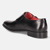 Black leather monk shoe by bugatti, featuring a buckle closure and red interior.