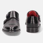 Black leather monk shoes by bugatti, with brogue detailing and a red lining.