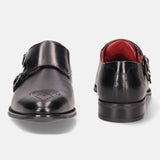 Black leather monk shoes by bugatti, with brogue detailing and a red lining.