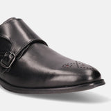 Black leather monk strap shoe by bugatti with decorative perforations at the toe.