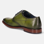 Green leather dress shoe by bugatti, featuring subtle antiqued detailing and a stacked heel.