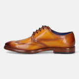 Yellow leather derby formal shoe by bugatti with dark navy laces and a visible blue insole.