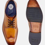 Yellow leather derby formal shoe by bugatti with decorative perforations, shown with a dark outsole.