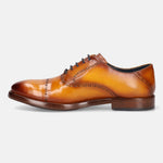 Yellow leather oxford by bugatti, featuring dark laces and decorative brogue detailing, in a side view.
