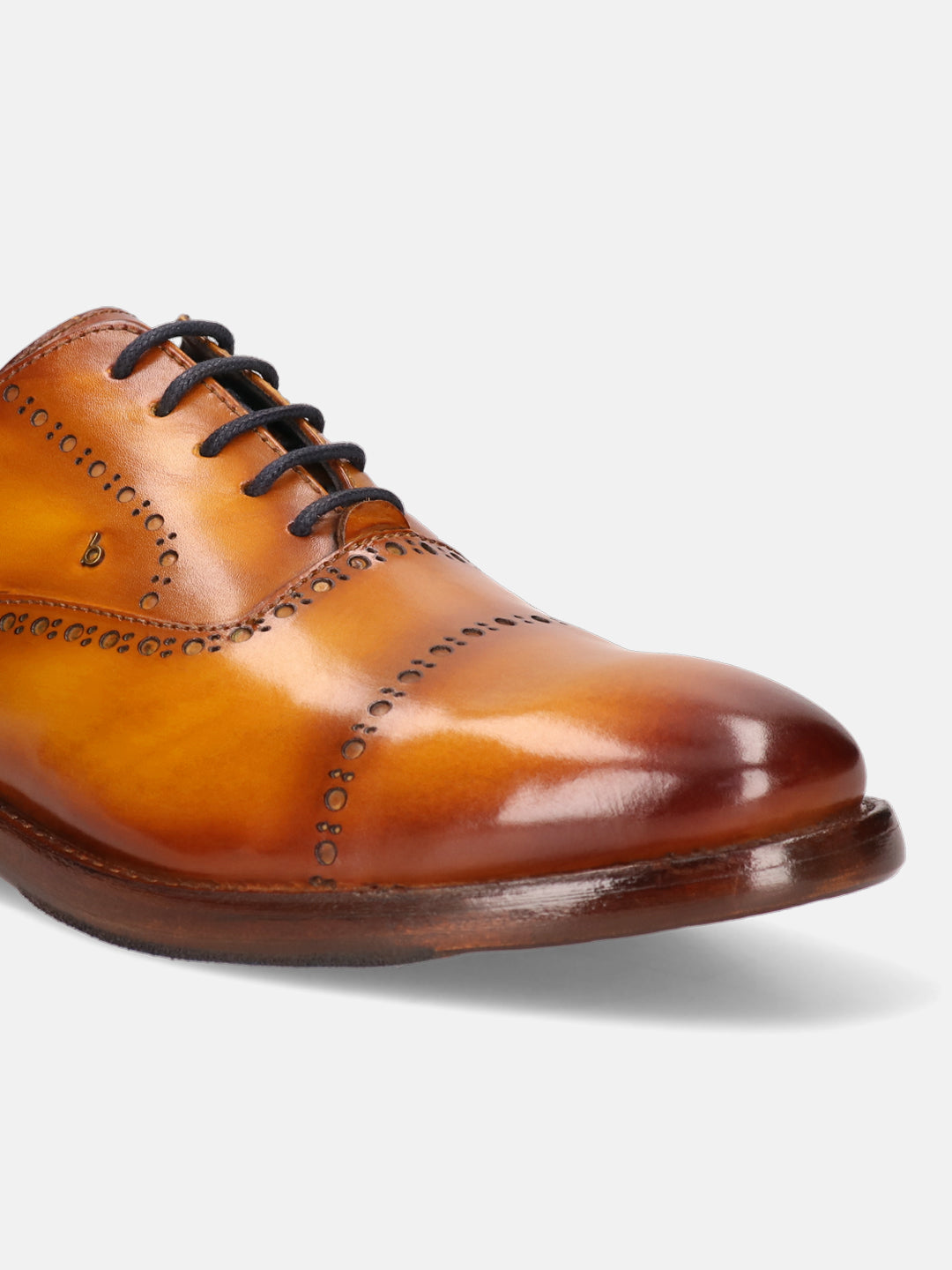 Yellow leather oxford formal shoe by Bugatti with brogue detailing and dark laces.