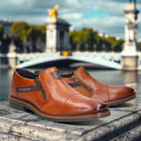 A cognac Men's bugatti Venetian Loafers featuring a round cap toe, moulded  heel, and a wide fit. Made from premium genuine leather with a durable tr outsole, this zipper design offers both style and comfort.