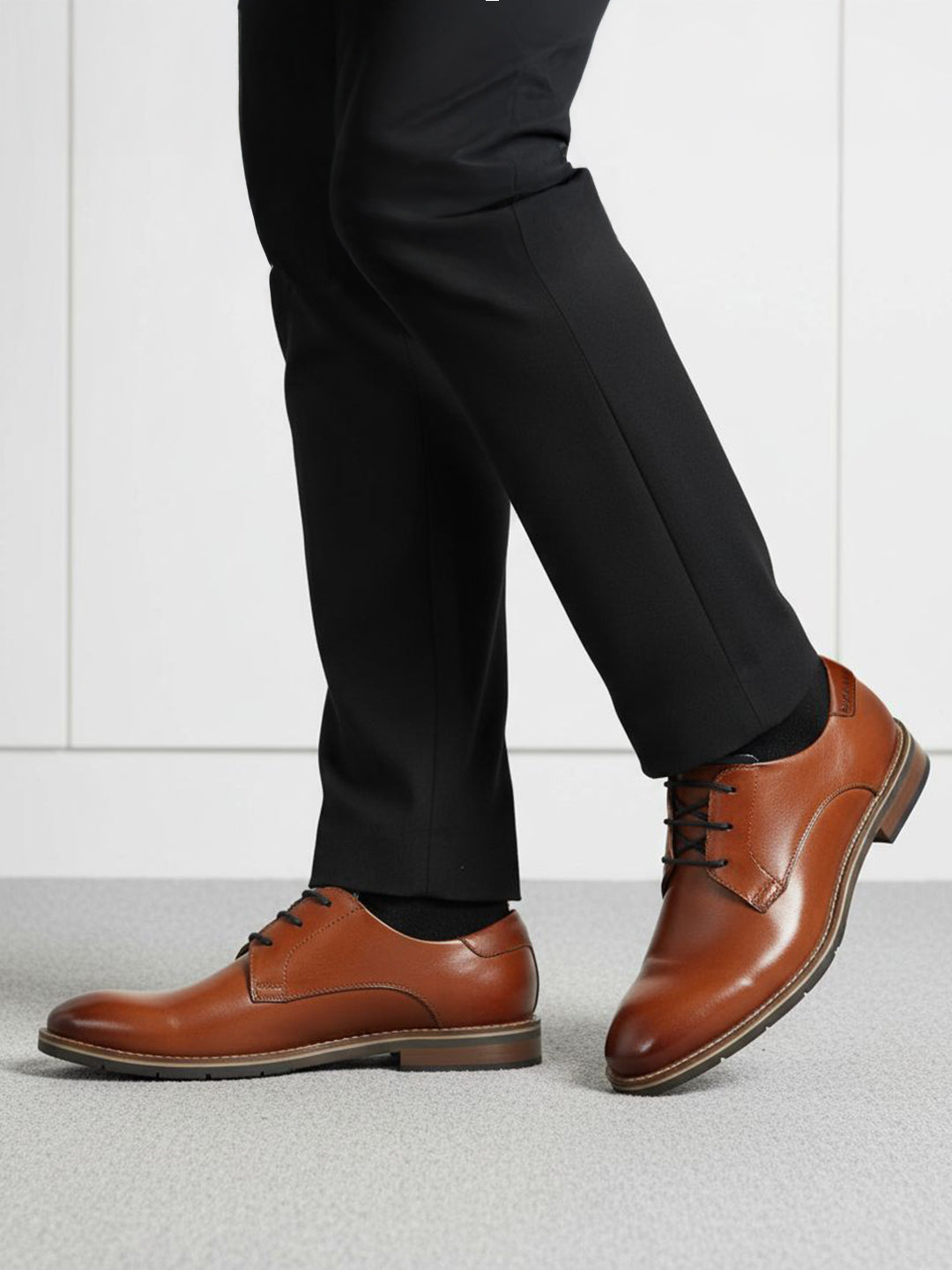 bugatti Laziano Comfort cognac leather dress shoes with black dress pants and socks.
