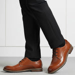 bugatti Laziano Comfort cognac leather dress shoes with black dress pants and socks.
