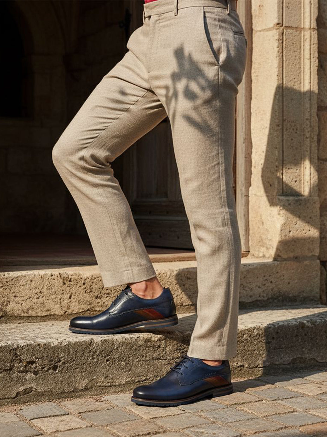 bugatti Caleo Exko dark blue leather derby shoes, accented with a brown stripe and paired with khaki trousers.

