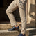 bugatti Caleo Exko dark blue leather derby shoes, accented with a brown stripe and paired with khaki trousers.
