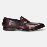A grey Men's bugatti Penny Loafer featuring a round toe apron toe, stacked heel. Made from premium genuine leather with a durable leather outsole, this slip-on design offers both style and comfort.