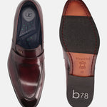 A grey Men's bugatti Penny Loafer featuring a round toe apron toe, stacked heel. Made from premium genuine leather with a durable leather outsole, this slip-on design offers both style and comfort.