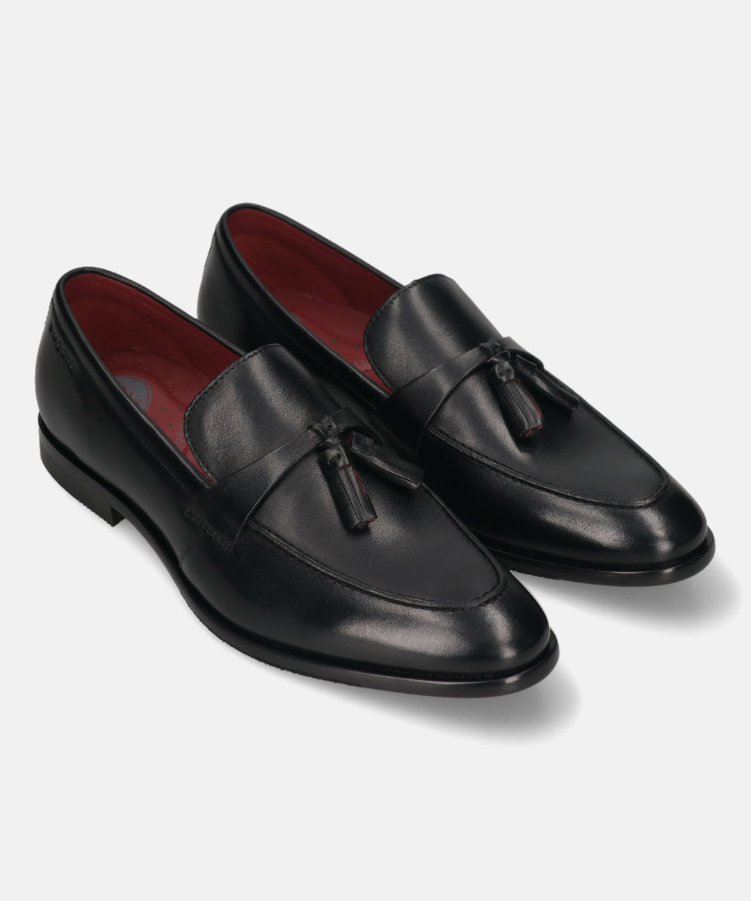 Pair of bugatti Rico black leather slip-on dress shoes with tassels and red lining.
