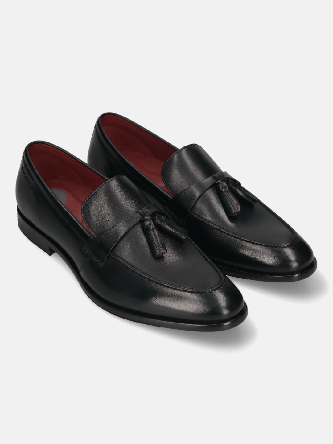 Pair of bugatti Rico black leather slip-on dress shoes with tassels and red lining.
