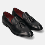 Pair of bugatti Rico black leather slip-on dress shoes with tassels and red lining.
