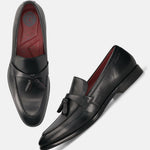 Black leather bugatti loafers with tassel detail, and a red inner lining.