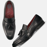 Black leather bugatti loafers with tassel detail, and a red inner lining.