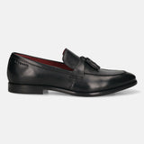 Side view of a black leather bugatti Rico slip-on loafer with a tassel.
