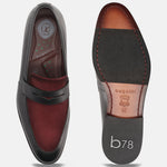 Black leather penny loafers by bugatti with a contrasting burgundy vamp, showing the insole and sole.