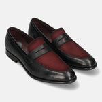 Black leather penny loafers by bugatti, featuring a burgundy suede vamp and subtle stitching details.
