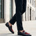 Lifestyle image of bugatti Rico black leather penny loafers with a burgundy suede accent.