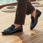 bugatti Rico black premium leather comfort penny loafers with blue accent on a boat deck.