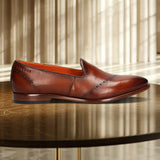 A cognac Men's bugatti Venetian Loafers featuring a round toe plain toe, stacked heel. Made from premium genuine leather with a durable leather outsole, this slip-on design offers both style and comfort.