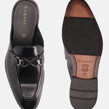 Black leather slip-on formal shoes by bugatti with a metal accent and a leather sole.