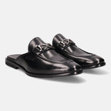 Black leather slip-on shoes by bugatti with silver-toned embellishments, displayed on a white backdrop.