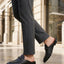 bugatti Rico black leather slip-on dress shoes with basket weave texture and a metal buckle.
