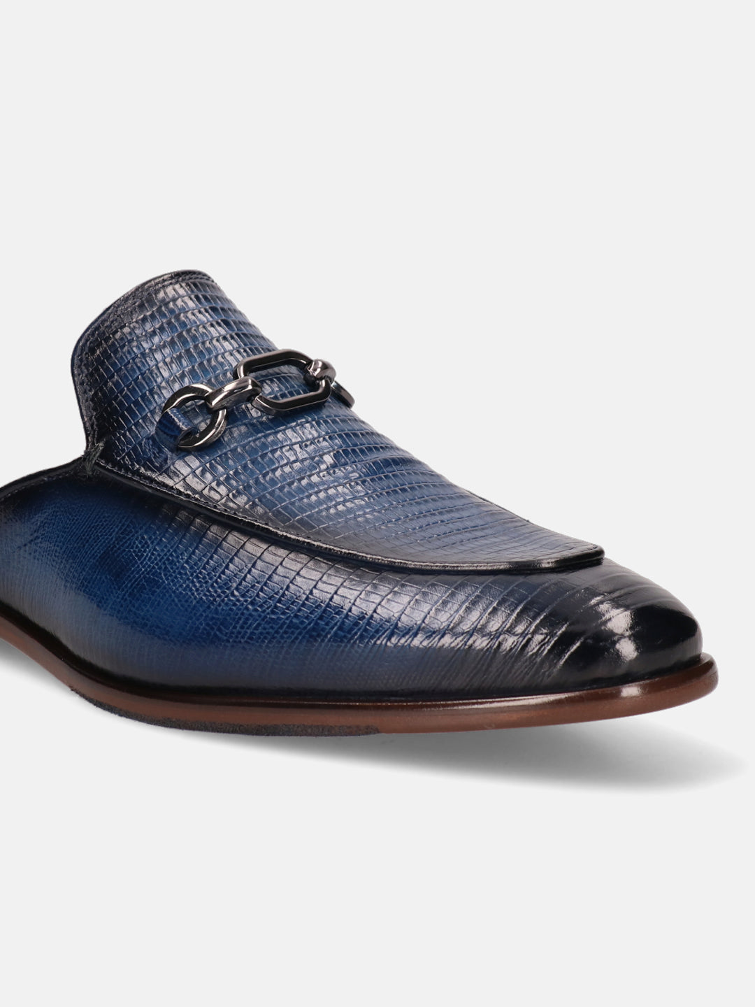 Blue leather slip-on shoe by bugatti, featuring a reptile scale texture and decorative metal chain.