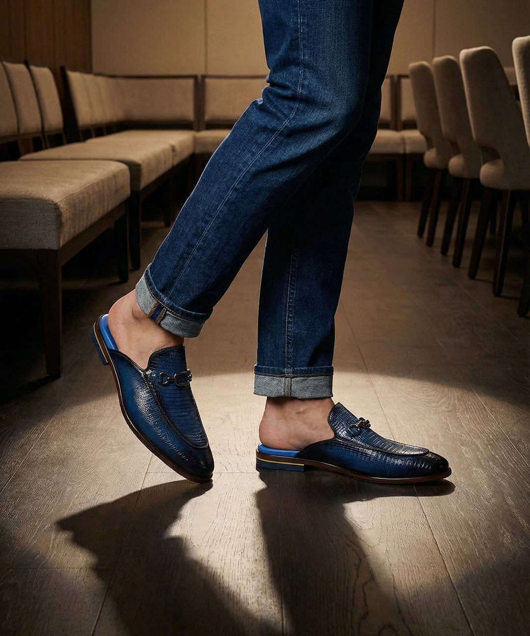 bugatti Rico Blue leather slip-on shoe with buckle detail, paired with blue denim jeans in a lifestyle shot.