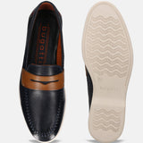 Dark blue leather slip-on shoes by bugatti with brown accents, featuring white stitching and textured soles.