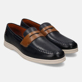 Blue leather slip-on shoes by bugatti, featuring a brown leather strap and white soles.