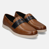 Cognac leather casual slip-on shoes by Bugatti, featuring a black strap, and tonal stitching.
