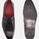 Black leather penny loafers by bugatti with decorative grid-textured panel and imprinted soles.