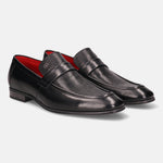 Black leather penny loafers by Bugatti, featuring a subtle perforated texture and red lining.