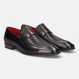 Black leather penny loafers by Bugatti, featuring a subtle perforated texture and red lining.