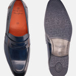Blue leather penny loafers by Bugatti, featuring a burnished finish and debossed text on the sole.