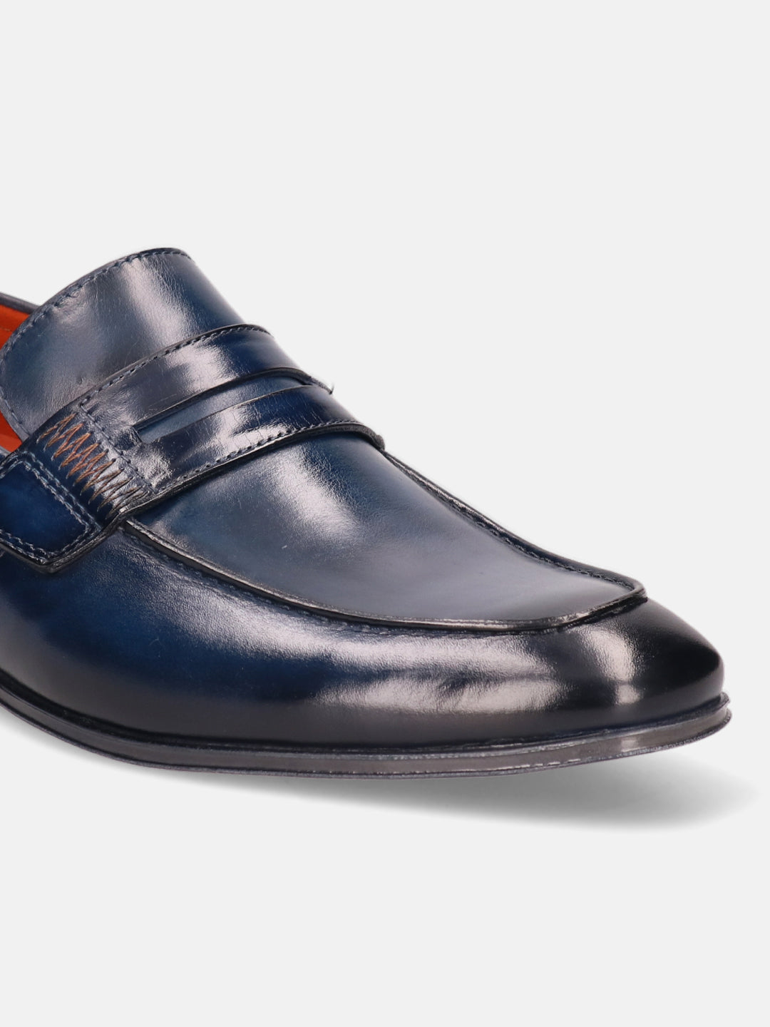 Blue leather penny loafer by Bugatti, showcasing fine stitching detail and a glossy finish.