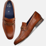 A cognac Men's bugatti Bit Loafer featuring a round toe apron toe, moulded  heel. Made from premium genuine leather with a durable high quality synthetic outsole, this slip-on design offers both style and comfort.