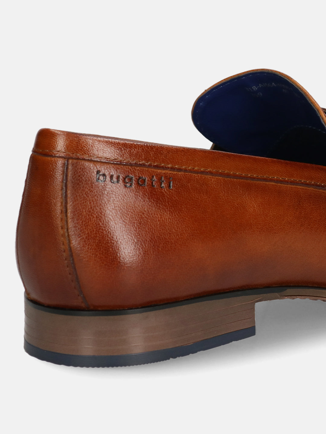 A cognac Men's bugatti Bit Loafer featuring a round toe apron toe, moulded  heel. Made from premium genuine leather with a durable high quality synthetic outsole, this slip-on design offers both style and comfort.