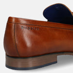 A cognac Men's bugatti Bit Loafer featuring a round toe apron toe, moulded  heel. Made from premium genuine leather with a durable high quality synthetic outsole, this slip-on design offers both style and comfort.