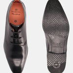 Black leather derby formal shoes by bugatti, displaying textured outsole and orange leather lining.