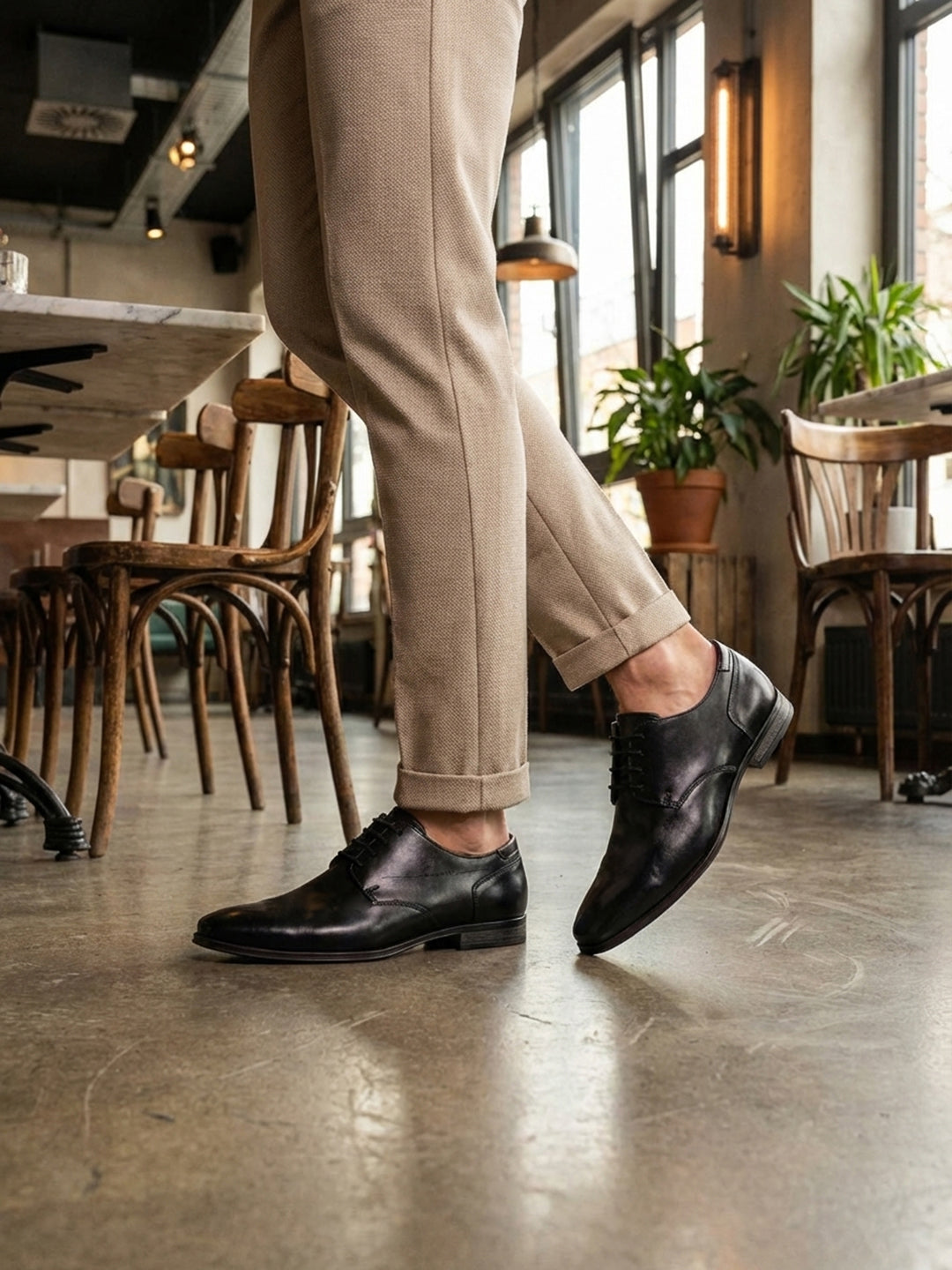 bugatti Margo black leather derby shoes with a lace-up closure and a sleek, formal design.
