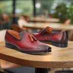 bugatti Margo red leather slip-on dress shoes with a woven texture and tassel detail.