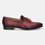 Red leather slip-on shoe by bugatti, with a woven pattern and decorative tassel.