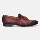 Red leather slip-on shoe by bugatti, with a woven pattern and decorative tassel.