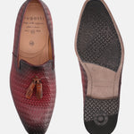 Red leather slip-on shoes by bugatti, featuring a woven texture and decorative tassels.